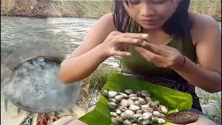 cooking in forest-  Cooking roasted oyster on a rock and eating delicious