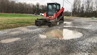 Soil conditioning a gravel parking area and removing potholes svl75 bobcat Harley rake