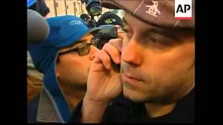 A survivor of a plane crash in New York City talks on the phone to a friend shortly after being resc