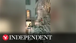 Ice and water flows through streets of Italian town after freak hail storm