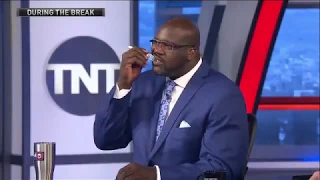 Shaq eating a burito during the break