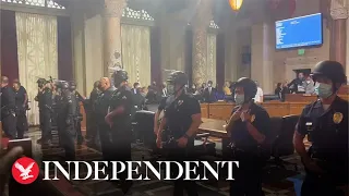 Riot police guard city hall as LA votes on controversial homelessness rule