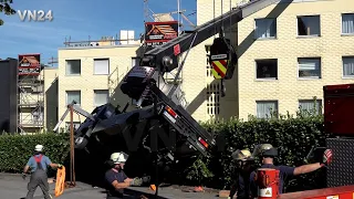 VN24 - Roofing crane tilts on house - fire department made efforts to recover it