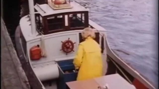 Woman in a yellow raincoat on a boat