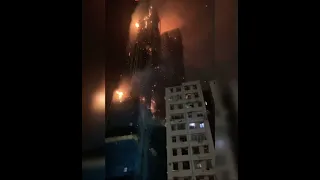 Building actually ON FIRE ! Looks like a movie set