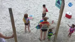 Ominous cloud drives bathers from Daytona Beach.