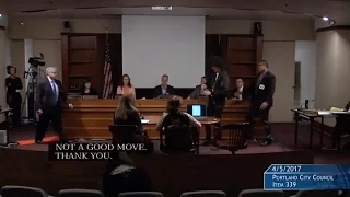 Portland protester hands Pepsi to mayor, disturbs city council meeting