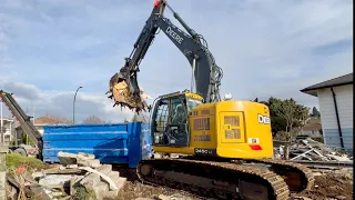 Excavator Loading Demolition Garbage Into Dumpsters