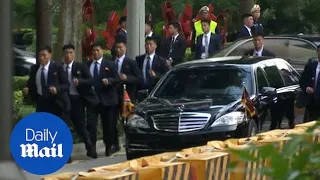 Kim Jong Un's bodyguards run beside his limo in Singapore