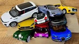 Box full of various miniature cars Peugeot, Volvo, Renault, Hyundai, Pagani, Cadillac One, DHL 28