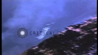 US Army Air Forces fighter attacking Japanese ship and warehouses at beach in the...HD Stock Footage
