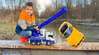 Darius plays rescue team for muddy tractor, cars and trucks | Kidscoco Club