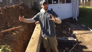Pulling a retaining wall straight with wall anchors.