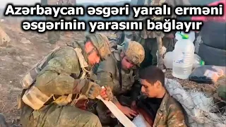 Azərbaycan əsgəri yaralı erməni əsgərinin yarasını bağlayır