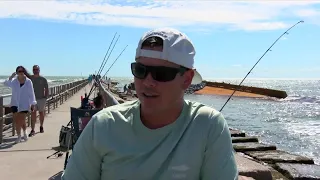 Beachgoers react to the large barge at Packery Channel