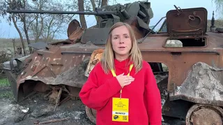 Girl sings Ukrainian national anthem next to a destroyed Russian tank