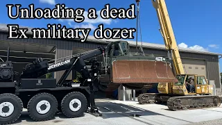 Unloading a very low hour ex military 850J John Deere dozer that does not run with HET wrecker/crane