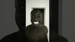 Black man smiling in the dark meme