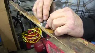 Bow making, debarking a yew English Longbow stave with a cabinet scraper
