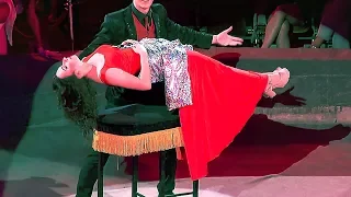 Circus. Magician and lady in red.