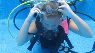 Hadley and Tami practice mask clearing and mask off drills with SCUBA instructor Gabrielle