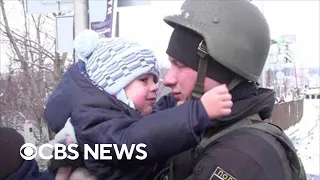 Ukrainian baby sobs uncontrollably as his father says goodbye