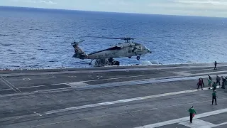 MH60 aka black hawk helicopter landing on an aircraft carrier