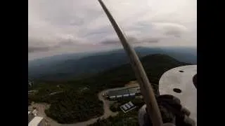 Helicopter mounting a 1 ton TV antenna on top of a tower on top of  a  mt. in Vermont