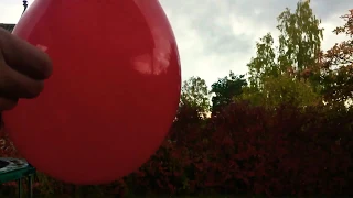 Water filled balloon exploding in slow motion