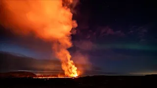 Northern Lights shine over erupting volcano in Iceland