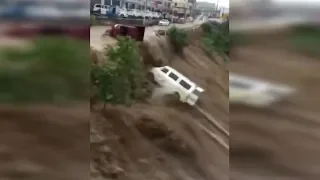 Flash floods sweep vehicles into river in SW China