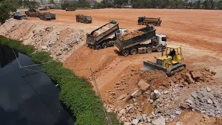 Continuing the work of the large land reclamation project by Team Operator Bulldozer Pushing Stone