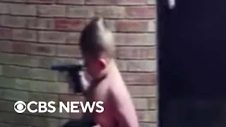 Toddler seen holding handgun outside apartment in surveillance video