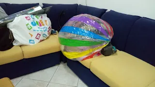 gigante beach ball deflating with an air pump[