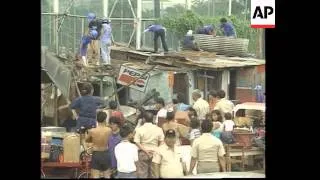 PHILIPPINES: DEMOLITION TEAM BEGINS TO PULL DOWN SQUATTERS HOMES