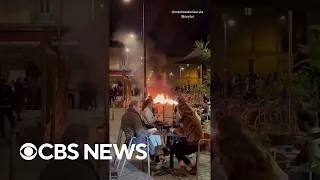 French diners have wine near fires lit by demonstrators protesting divisive pension reforms #shorts