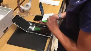 An apple specialist installing screen protector to a new iPhone 7