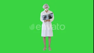 Woman Doctor in Mask Looking at Lung Xray on a Green Screen, Chroma Key. | Stock Footage - Video...