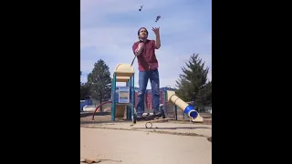 Man Standing on Hoverboard Balances on Rola Bola and Juggles Knives - 1197025