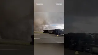 Cars drive by tornadoes tearing across Texas and Nebraska