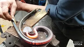 Forging a trivet with a jig and some tools.