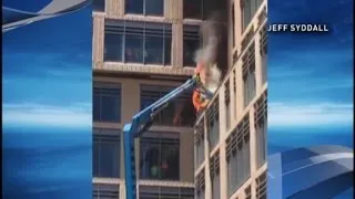 Construction workers jump from burning lift