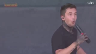 tyler joseph holds a mic reverse and acts like he sings during fairly local