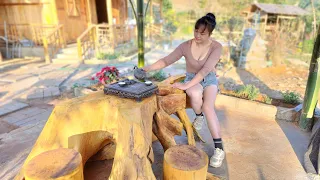 The girl took the tree stump and made it into a table and chairs set, placing it in the resort hut