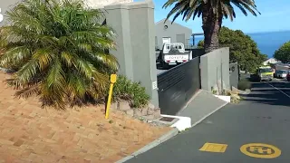 Driving through Llandudno to the Sandy Bay Beach parking area Cape Town's nudist beach