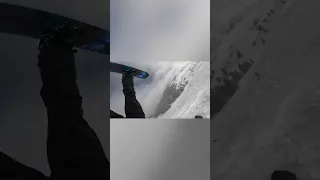 Snowboarder Jumps off Ramp Landing Upside Down