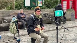 Extremely talented guitarist & singer. Musician Piotr Kołodziej busking in Brighton New Road.