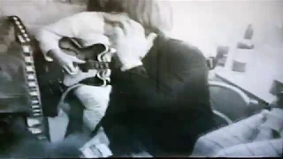 Backstage fun with the Rolling Stones – Bill Wyman plays a cigarette trick on Charlie Watts