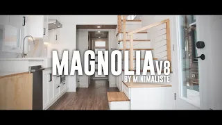 Bright and elegant, this luxurious tiny home features motorized blinds and rooftop deck!