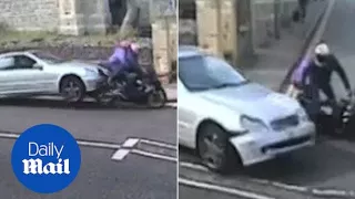 Dangerous driver rams motorcyclist with passenger while moving - Daily Mail